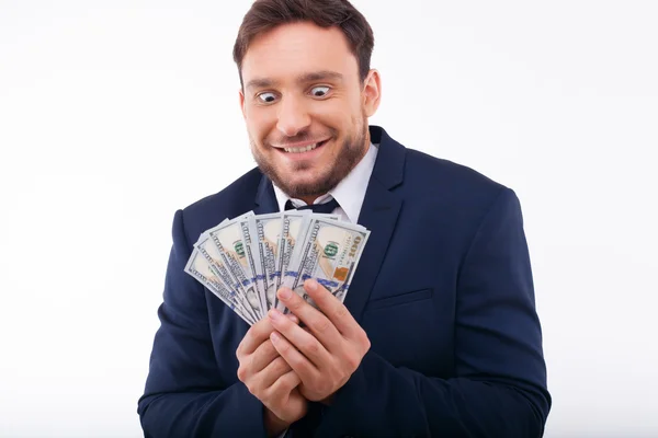 Cheerful young guy is crazy about dollars — Stockfoto
