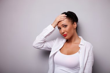 Cheerful young woman is strongly ashamed of something