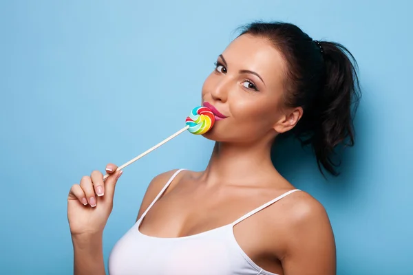 Attractive young woman with sweet appetizing lollipop — Stok fotoğraf