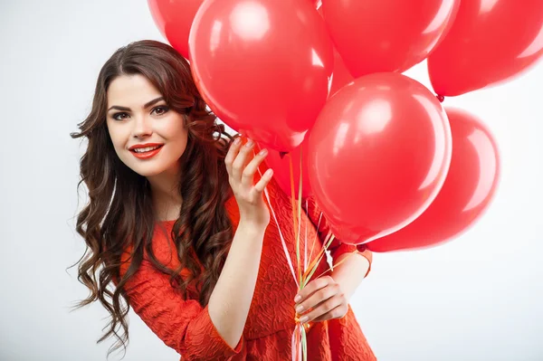 Pretty young woman in red dress is celebrating — Stock Photo, Image