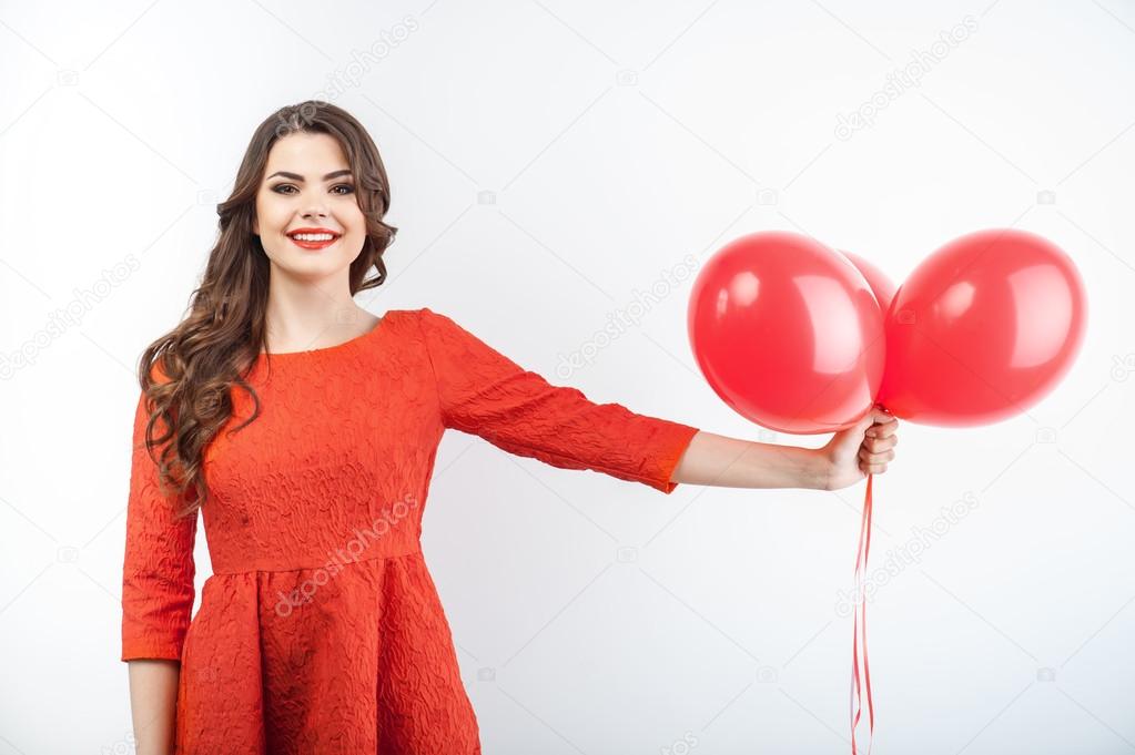 Beautiful young girl with pretty smile in red dress