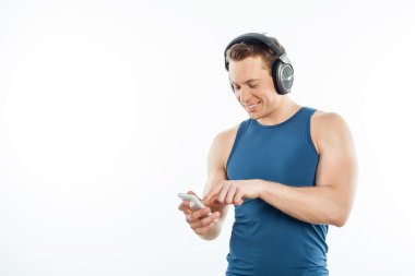 Cheerful young guy is relaxing and selcting songs