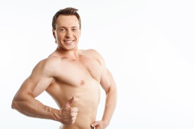 Attractive young bodybuilder is expressing positive emotions