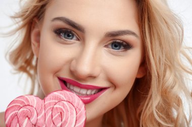Beautiful young girl is holding sweet food