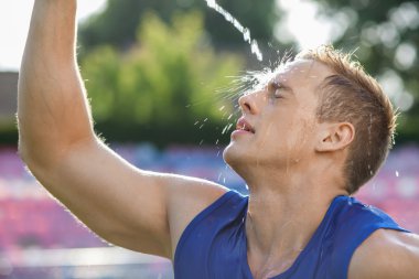 Attractive young athlete is very hot and tired