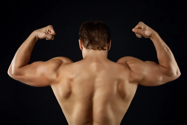 Beautiful young sportsman is showing his trained body — Φωτογραφία Αρχείου