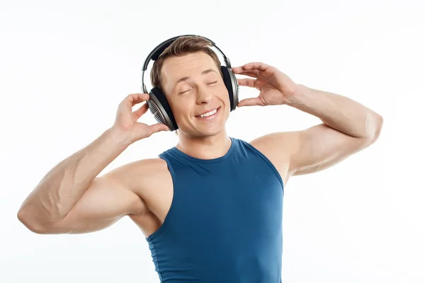 Beautiful young man is relaxing with earphones — ストック写真