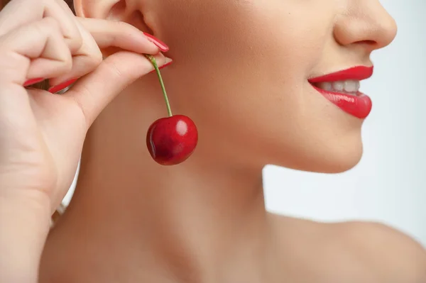 Hermosa mujer joven con un bonito pendiente rojo — Foto de Stock