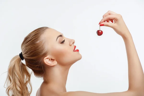 Attractive young girl with sweet red berry — 스톡 사진