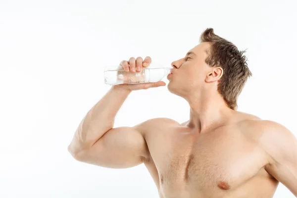 Cheerful healthy young man is very thirsty Royalty Free Stock Images