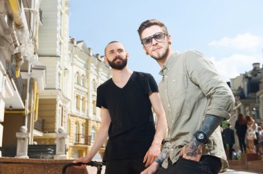 Attractive young men are traveling across city