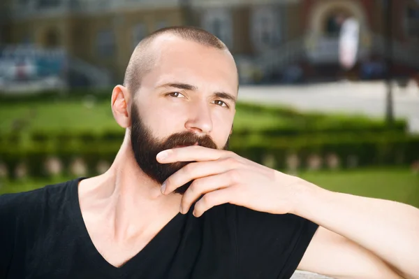 Attractive young hipster guy is having rest outdoors — Stockfoto