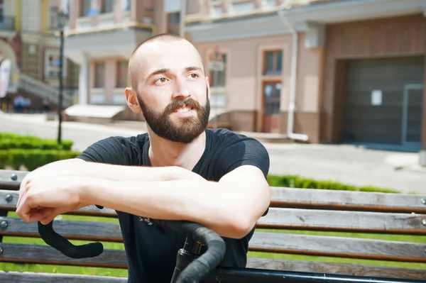 Handsome young hipster guy is having rest — Stockfoto