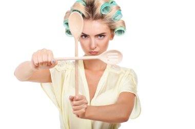 Attractive young woman is protecting her kitchen