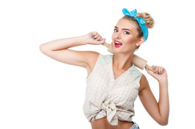 Cheerful young woman is making fun before baking clipart