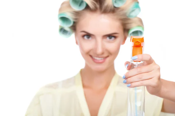 Cheerful young woman is presenting fluid medium for cleaning — Stok fotoğraf