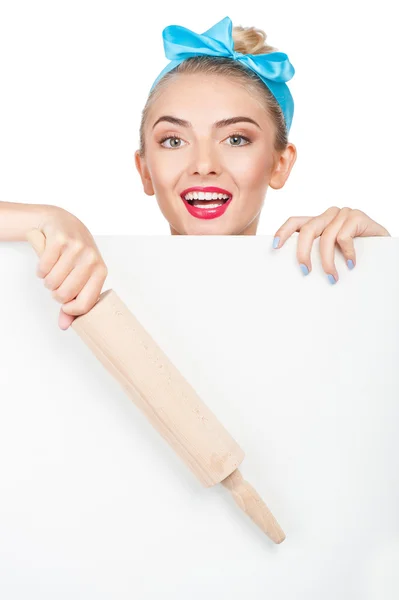 Cheerful young woman is hiding behind white barrier — Stockfoto