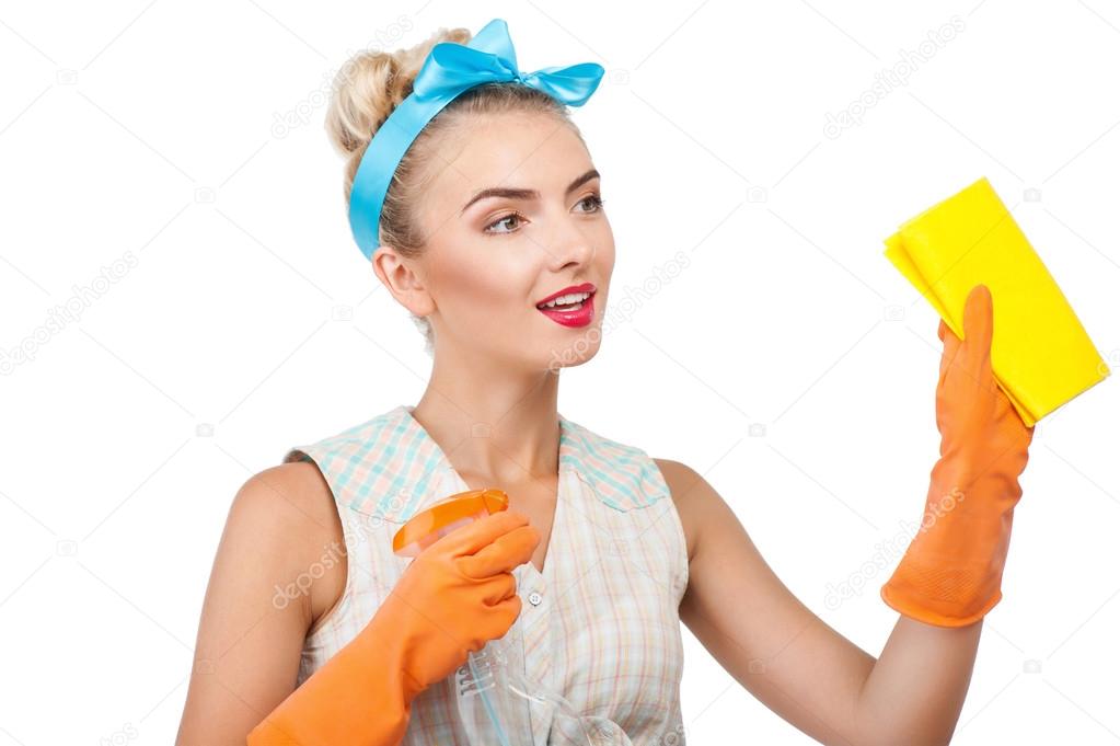 Attractive young blond housewife is doing cleanup