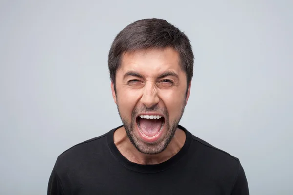 Furious young man is evincing negative emotions — Stock Photo, Image