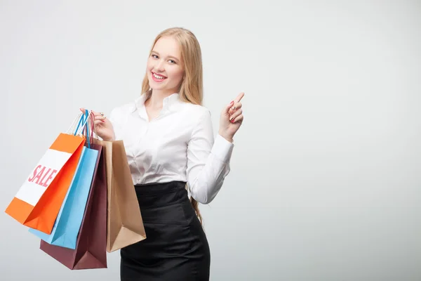 Cheerful young girl is doing shopping happily — Stock fotografie