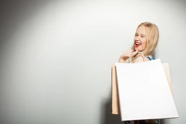 Attractive young girl is crazy about shopping — Stock Photo, Image