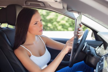 Attracting young woman is signing papers of buying transport