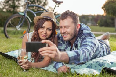 Cheerful young loving couple is dating in the nature