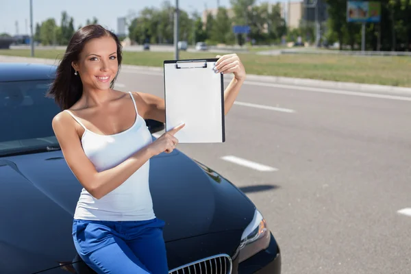 Cheerful young woman wants to by a modern transport — ストック写真