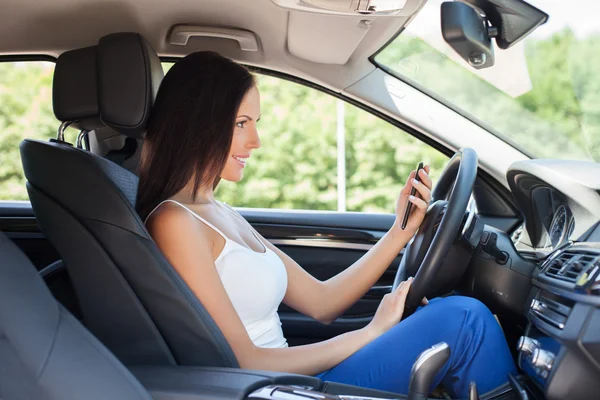 Beautiful young girl is photographing herself in her transport — Stock Photo, Image