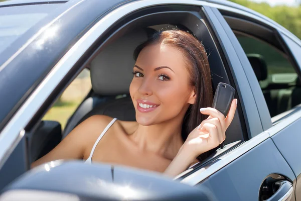 Pretty young girl is presenting her new transport — Stock Photo, Image