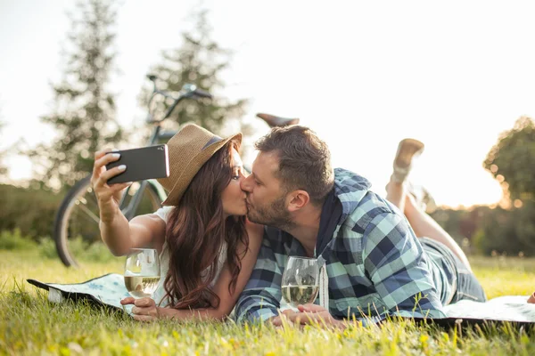 Cute young loving couple are photographing themselves in the nature — Stock Photo, Image