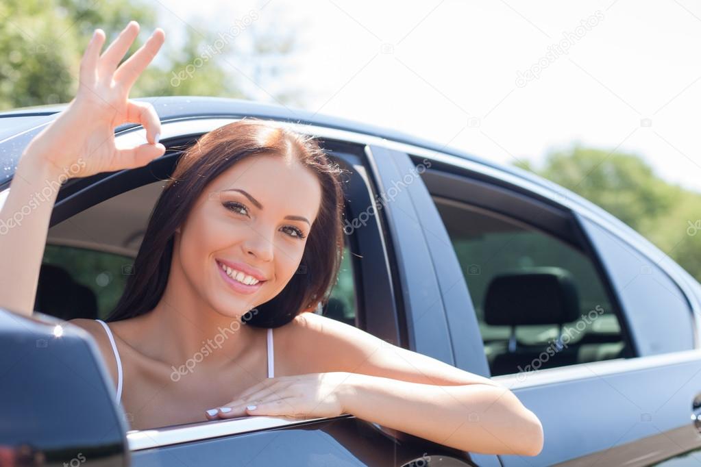 Cheerful young woman is expressing positive emotions in transport