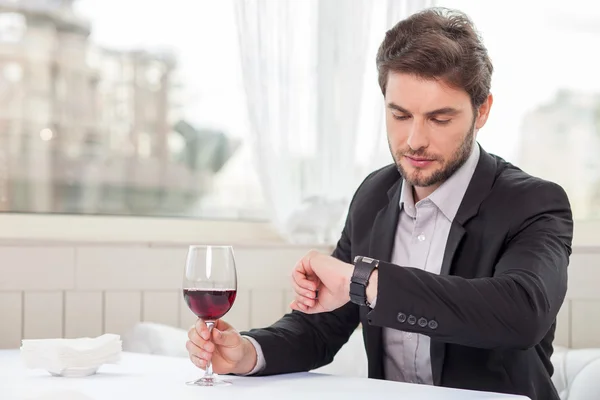 Attractive young businessman is waiting for his client