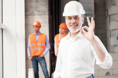 Cheerful construction team is satisfied with their work