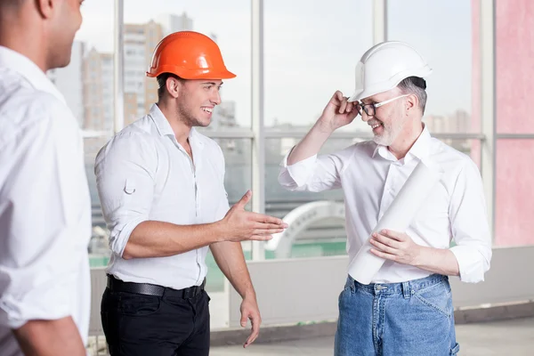 Cheerful builders are working on their new project — Stock Photo, Image