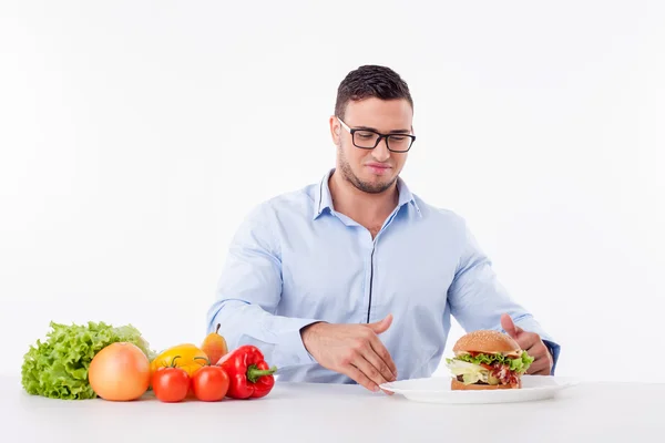 Cheerful young guy is denying unhealthy food — Stock Photo, Image