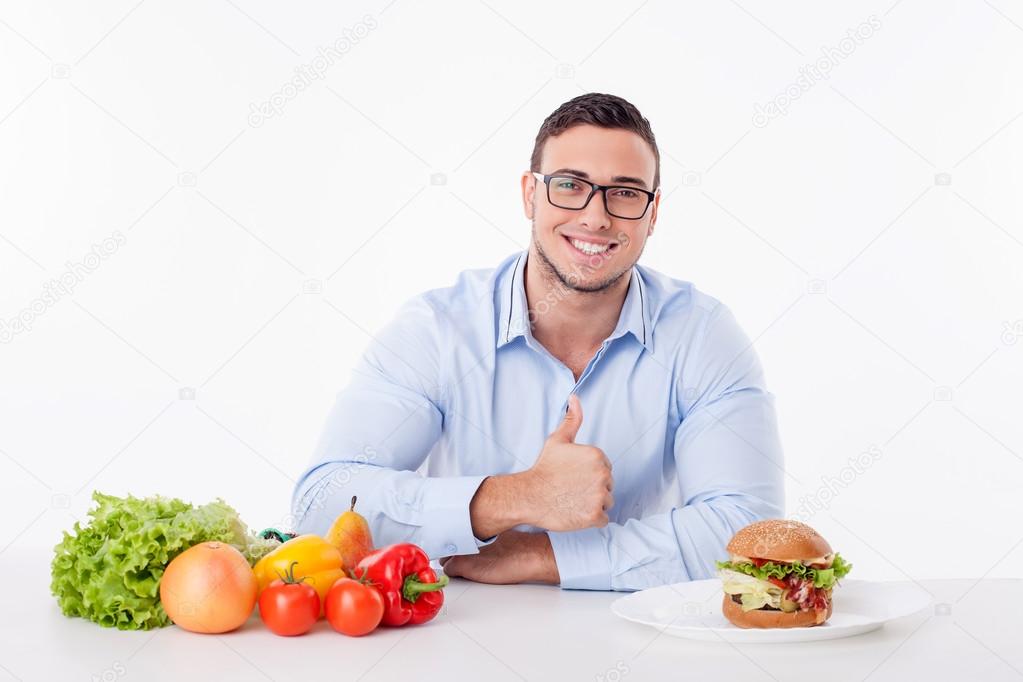Attractive young man with pretty smile is very hungry
