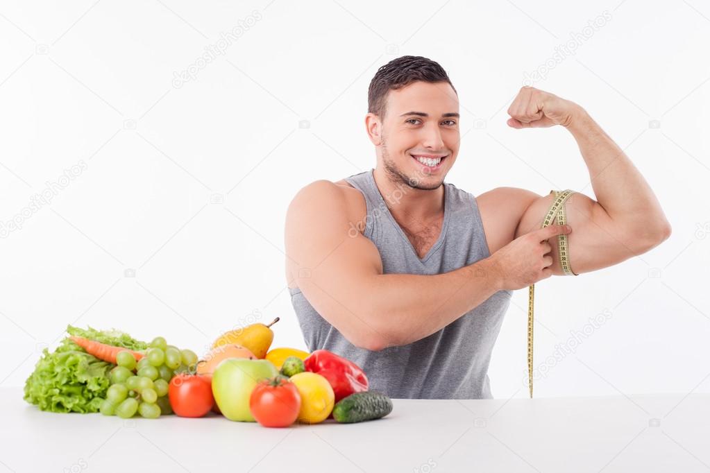 Cheerful young guy is choosing healthy eating