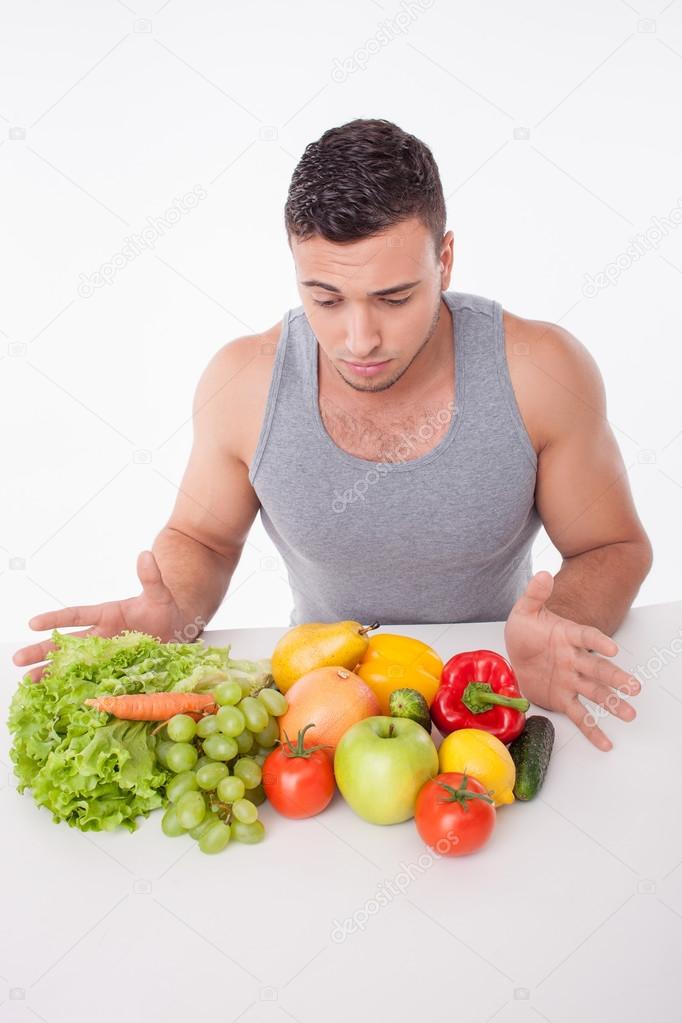 Cheerful young fit man is very hungry