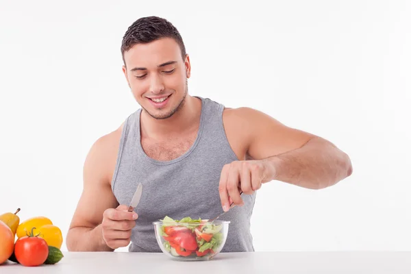 Cheerful young fit guy is very hungry — Stock Photo, Image