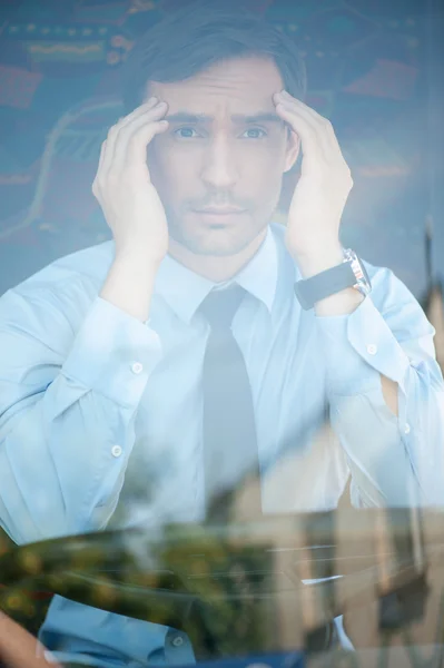 Cheerful young man is driving transport with headache — Zdjęcie stockowe