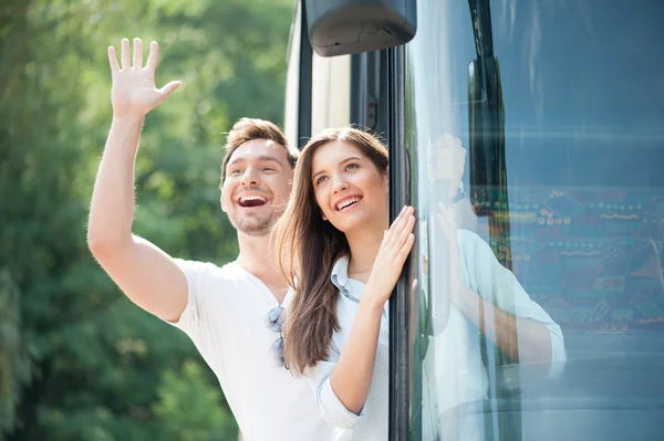 Cheerful loving couple is making fun in transport — Stock Photo, Image