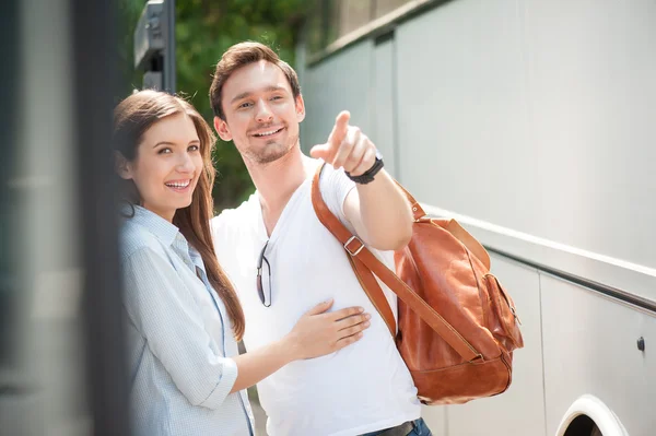 Cheerful man and woman are waiting for bus departure — Stock Photo, Image