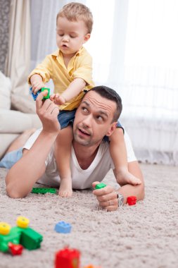 Cheerful man and his child are spending time together