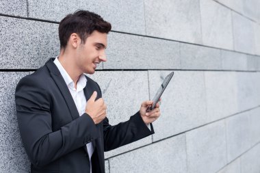 Handsome young businessman is using modern technology