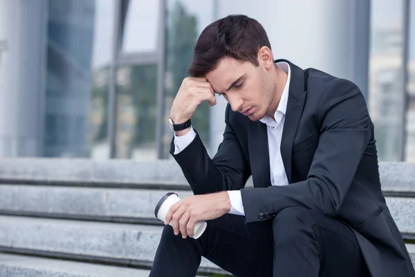 Attractive young businessman is worrying about his job — Stok fotoğraf