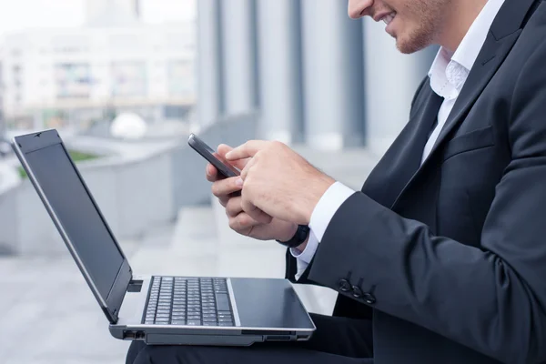 Successful man in suit is messaging to his business partner — Stok fotoğraf