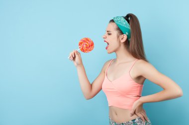 Attractive young woman is playing with candy