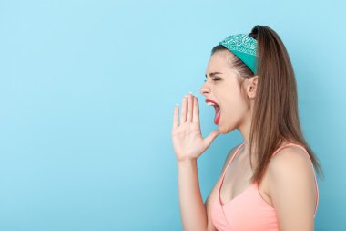 Cheerful young hipster girl is expressing negative emotions