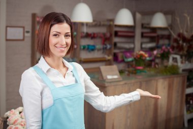 Cheerful young florist is presenting her workshop